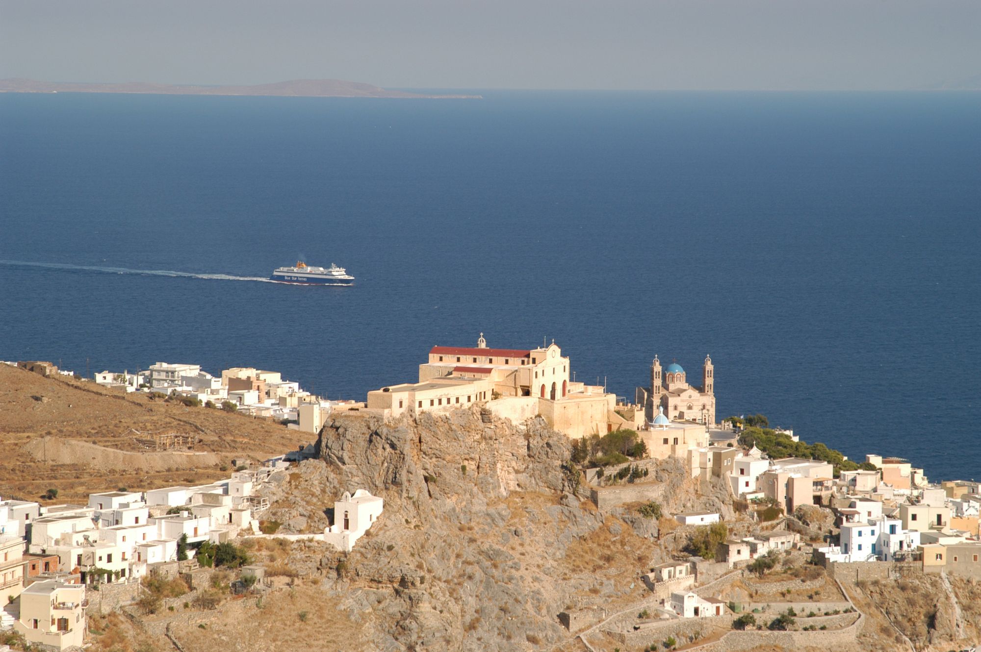 Saint George catholic church in Syros and the blue sea at the background.