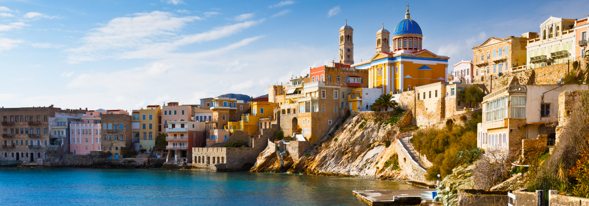 “Asteria” beach in Syros overlooking the neoclassical mansions of the island and Saint Nikolas church.