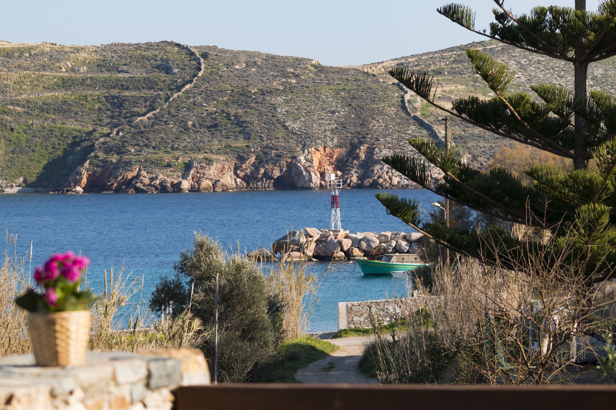 Amazing sea view to Achladi Beach in Syros and in the background the lighthouse. 