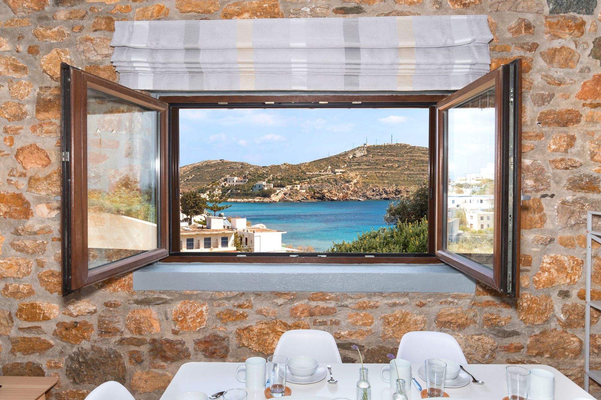 Sea view from the window of a stone built Syra Suite residence.