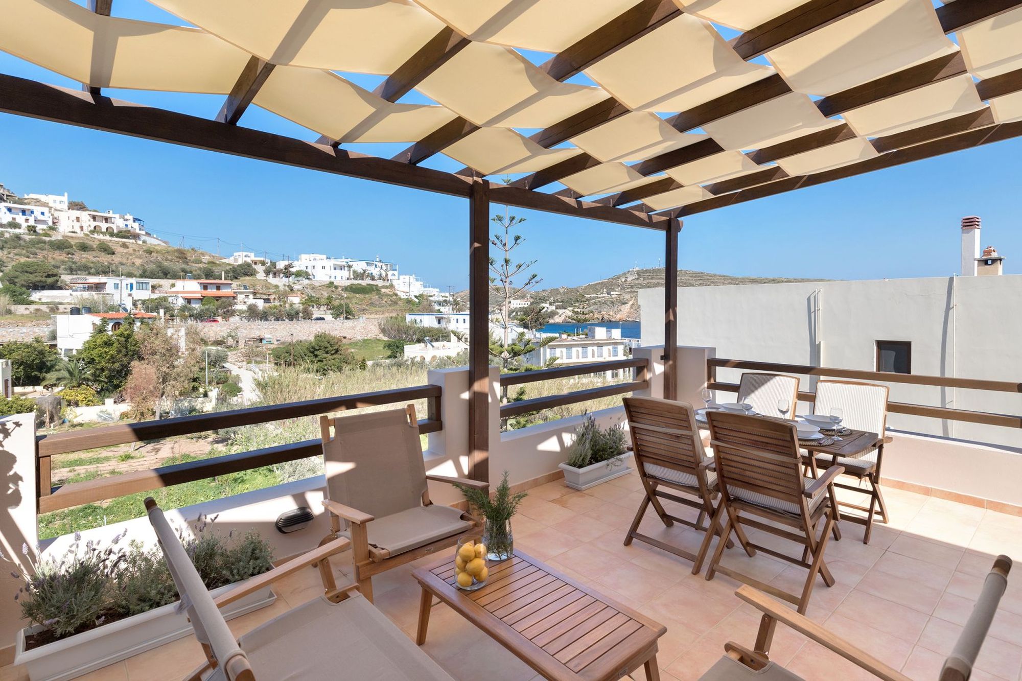 Fully furnished sea view veranda with pergola, lounge and dining table for four persons.
