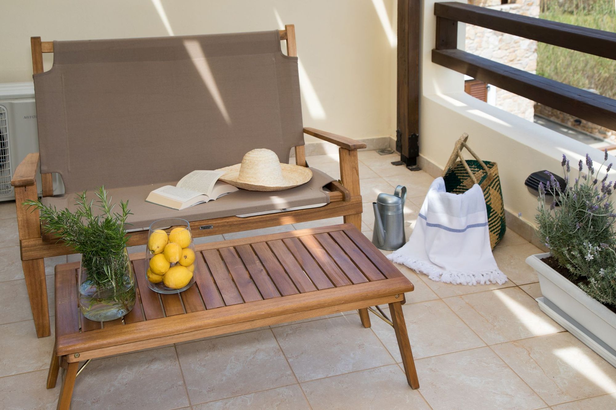 Veranda with a wooden sofa and a coffee table.